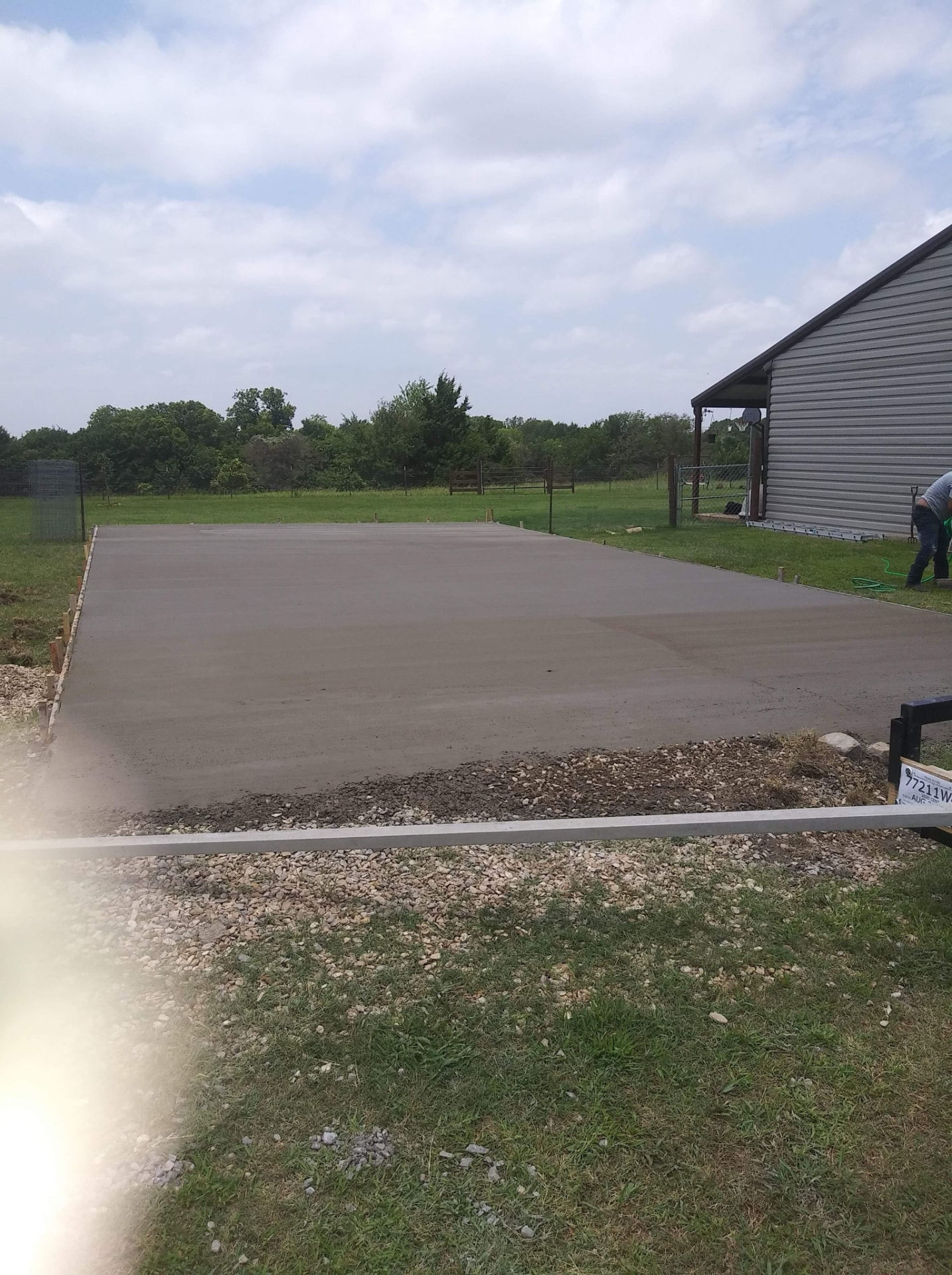 Large newly poured concrete driveway beside a Texas home