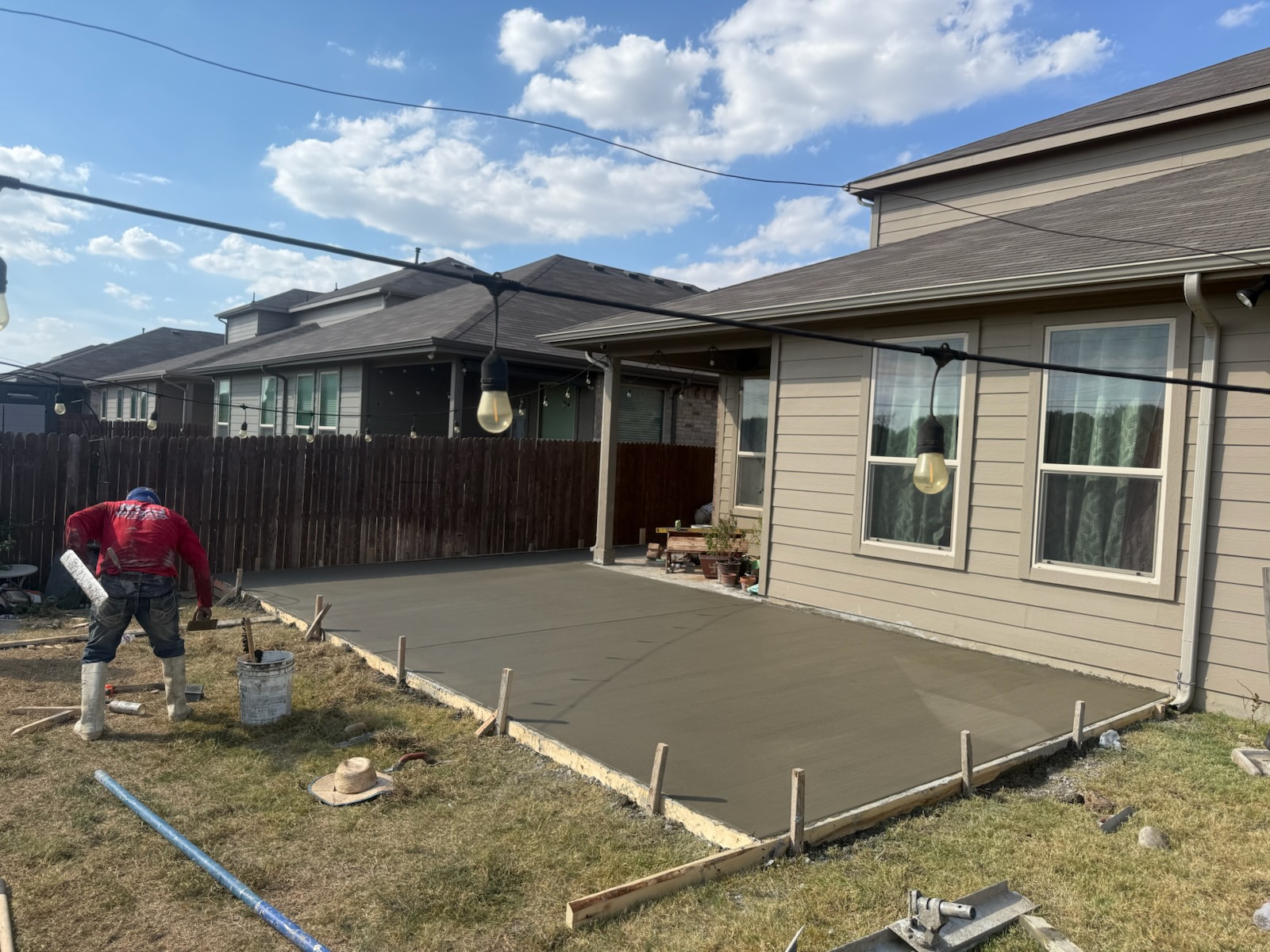 Freshly finished concrete patio beside a home